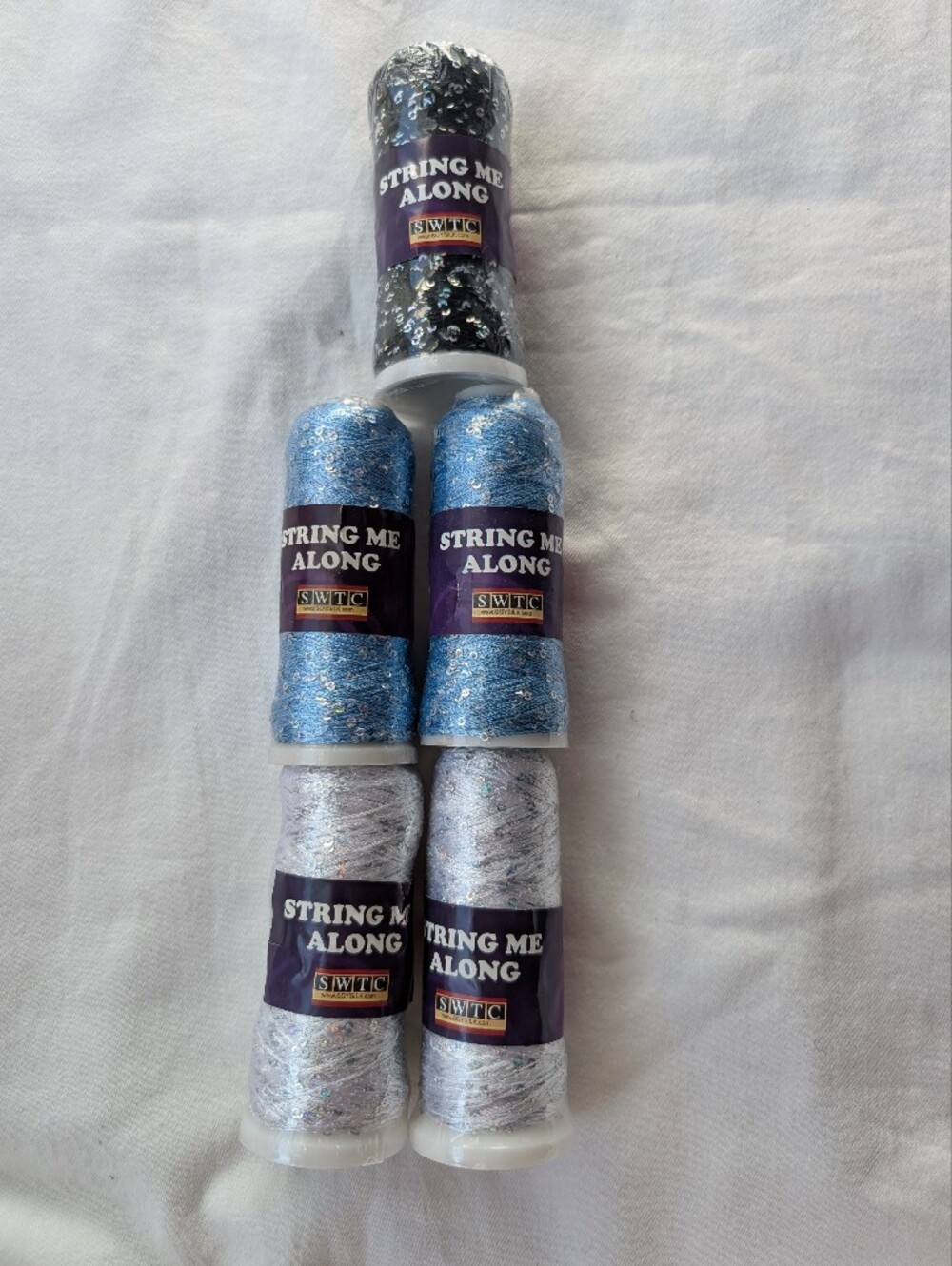 SWTC String Me Along Sequin Carry-Along Art Yarn - 2 Blue 2 White 1 Black